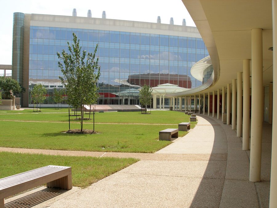 Modern corporate office building in landscaped park with benches